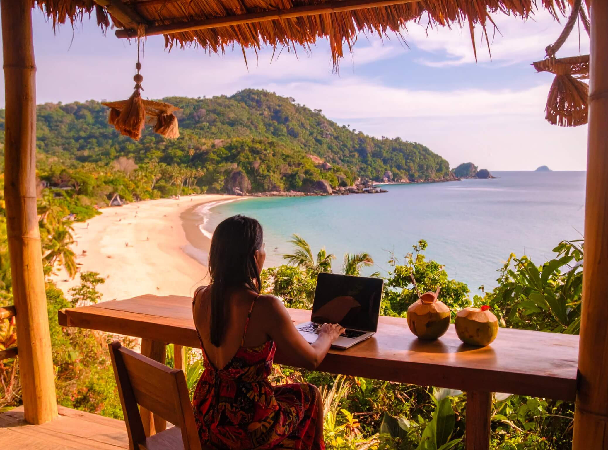 Mood image image of a beach scene with a tablet on a table at a beach bar